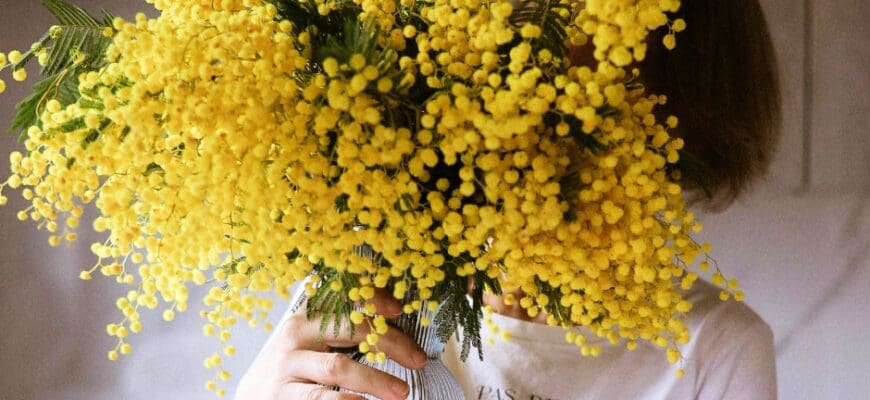 Women Holding a Vase with yellow Flowers Covering her Face
